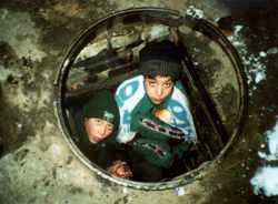 Homeless children living in a manhole are helped by the charity Child Aid.